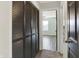 Hallway leading to a bedroom with a ceiling fan and neutral colored walls at 3423 Shadow Bend Dr, Columbus, IN 47201
