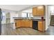 Open-concept kitchen featuring wood cabinets, stainless dishwasher, breakfast bar and eat-in dining space at 3423 Shadow Bend Dr, Columbus, IN 47201