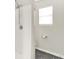 Shower stall with white tile and a chrome shower head, plus a window for natural light at 3423 Shadow Bend Dr, Columbus, IN 47201