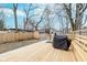 Spacious backyard with a wooden deck, grill, and fenced perimeter at 3550 N Illinois St, Indianapolis, IN 46208