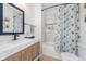 Stylish bathroom with a shower/tub combo, patterned shower curtain and a modern vanity at 3550 N Illinois St, Indianapolis, IN 46208