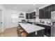 Stylish kitchen featuring dark cabinetry, a large island, and stainless steel appliances at 3550 N Illinois St, Indianapolis, IN 46208
