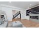 Open-concept living room with modern fireplace and view of the staircase at 3550 N Illinois St, Indianapolis, IN 46208