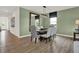 Dining room features a long wood table with seating for six and elegant light fixture at 3706 Cantebury Dr, Franklin, IN 46131
