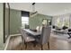 Well-lit dining room with wood table set for six, view into the living room at 3706 Cantebury Dr, Franklin, IN 46131