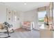 Charming Bedroom with a white crib, rocking chair, shiplap accent wall, and delightful animal-themed artwork at 3745 Cantebury Dr, Franklin, IN 46131