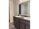 Bathroom vanity featuring dual sinks, dark cabinets, and a large mirror at 3825 Windstar Way, Columbus, IN 47203