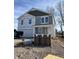 Two-story home featuring gray siding, a covered porch, and stacked brick in the front yard at 3825 Windstar Way, Columbus, IN 47203