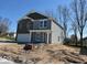 Charming two-story home showcasing a brick facade, gray siding, and a well-maintained lawn at 3825 Windstar Way, Columbus, IN 47203