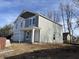 Exterior view of a two-story home featuring gray siding and white trim at 3825 Windstar Way, Columbus, IN 47203