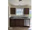 Well-equipped kitchen with stainless steel dishwasher, and dark cabinets at 3825 Windstar Way, Columbus, IN 47203