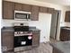 Modern kitchen featuring stainless steel appliances, granite countertops, and dark cabinets at 3825 Windstar Way, Columbus, IN 47203