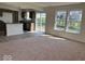 Open-concept living room and kitchen with large windows and ample natural light at 3825 Windstar Way, Columbus, IN 47203