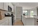 Well-lit kitchen with stainless steel appliances, spacious countertops, and a convenient center island at 3870 Flora Dr, Franklin, IN 46131