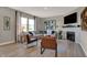 Bright living room featuring a comfortable sectional sofa, fireplace, and large windows for ample natural light at 3870 Flora Dr, Franklin, IN 46131