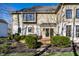 Exterior view of backyard with a deck, patio table, and mature landscaping at 4243 Riverbirch Run, Zionsville, IN 46077