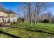 Large backyard with a patio, patio table, mature trees, and play set at 4243 Riverbirch Run, Zionsville, IN 46077
