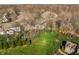 Aerial view of a large backyard with lush lawn, mature trees, a play set, and surrounding neighborhood homes at 4243 Riverbirch Run, Zionsville, IN 46077