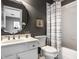 Stylish bathroom with unique mirror, modern fixtures, and shower-tub with curtain at 4243 Riverbirch Run, Zionsville, IN 46077