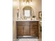 Updated bathroom featuring a modern vanity with gold fixtures, round mirror, and white countertops at 4243 Riverbirch Run, Zionsville, IN 46077
