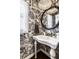 Stylish powder room features black and white patterned wallpaper and a pedestal sink at 4243 Riverbirch Run, Zionsville, IN 46077