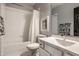 Well-lit bathroom with a white vanity, bath and shower with a framed mirror at 4243 Riverbirch Run, Zionsville, IN 46077