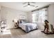 Bright bedroom with a ceiling fan, charming accents and a natural light from a large window at 4243 Riverbirch Run, Zionsville, IN 46077