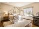 Bright bedroom featuring a four-poster bed, hardwood floors and a large window with natural light at 4243 Riverbirch Run, Zionsville, IN 46077