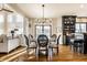 Dining room with a chandelier and seamless flow to the adjacent open concept living room at 4243 Riverbirch Run, Zionsville, IN 46077