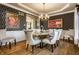 Elegant dining room features custom wallpaper, a modern chandelier, and seating for six at 4243 Riverbirch Run, Zionsville, IN 46077