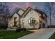 Beautiful white brick home showcasing a long driveway and professionally landscaped yard at 4243 Riverbirch Run, Zionsville, IN 46077