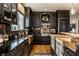 Custom kitchen featuring dark wood cabinets, copper sink, Wolf range, and butcher block island at 4243 Riverbirch Run, Zionsville, IN 46077