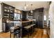 A custom kitchen features dark wood cabinetry, butcher block island, and stainless appliances at 4243 Riverbirch Run, Zionsville, IN 46077