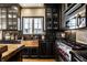Updated kitchen showcasing dark wood cabinetry, stainless steel appliances, and a copper sink at 4243 Riverbirch Run, Zionsville, IN 46077