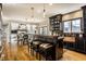 Open-concept kitchen with dark wood cabinetry, seating at the island, and hardwood floors at 4243 Riverbirch Run, Zionsville, IN 46077