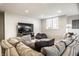 Basement living room with large sectional couch, TV, and plenty of seating at 4243 Riverbirch Run, Zionsville, IN 46077