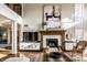 Living room with fireplace and decor, featuring a tall ceiling with lots of bright, natural light at 4243 Riverbirch Run, Zionsville, IN 46077