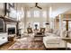 Bright living room with high ceilings, fireplace, and large windows create a welcoming atmosphere at 4243 Riverbirch Run, Zionsville, IN 46077