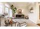 Bright living room features large windows, stylish furniture, and neutral decor at 4243 Riverbirch Run, Zionsville, IN 46077