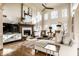 Comfortable living room with a fireplace, tall windows, and neutral tones create a relaxing space at 4243 Riverbirch Run, Zionsville, IN 46077