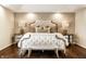 Luxurious main bedroom featuring a decorative accent wall, mirrored nightstands, and a tufted headboard at 4243 Riverbirch Run, Zionsville, IN 46077