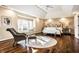Inviting main bedroom featuring a vaulted ceiling, large windows, a sitting area and hardwood floors at 4243 Riverbirch Run, Zionsville, IN 46077