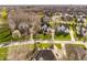 Aerial view showcasing a beautiful neighborhood with well-maintained homes, mature trees, and green lawns at 4243 Riverbirch Run, Zionsville, IN 46077