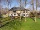 Spacious backyard featuring a well-maintained lawn, mature trees, and a deck for outdoor entertaining at 4243 Riverbirch Run, Zionsville, IN 46077