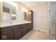 Modern bathroom with double vanity, storage tower, and glass shower at 5421 Upper Garden Way, Zionsville, IN 46077