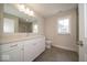 Modern bathroom with a large mirror, vanity with double sinks, and stylish tile flooring at 5421 Upper Garden Way, Zionsville, IN 46077