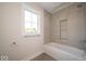 Bright bathroom features a tub-shower combo with tiled walls and a window for natural light at 5421 Upper Garden Way, Zionsville, IN 46077