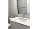 Bathroom vanity with stone countertop, modern faucet, and large mirror at 5421 Upper Garden Way, Zionsville, IN 46077