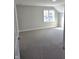 Large, bright bedroom featuring plush carpeting, crisp white trim, and a large window at 5421 Upper Garden Way, Zionsville, IN 46077