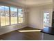 Open dining room with ample natural light, hardwood floors, and access to a porch at 5421 Upper Garden Way, Zionsville, IN 46077